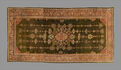 Appraisal: PERSIAN LONG CARPET The abrashed green field worked with central