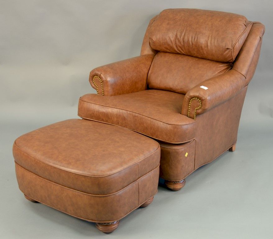 Appraisal: Leather upholstered chair and ottoman ht in wd in Leather