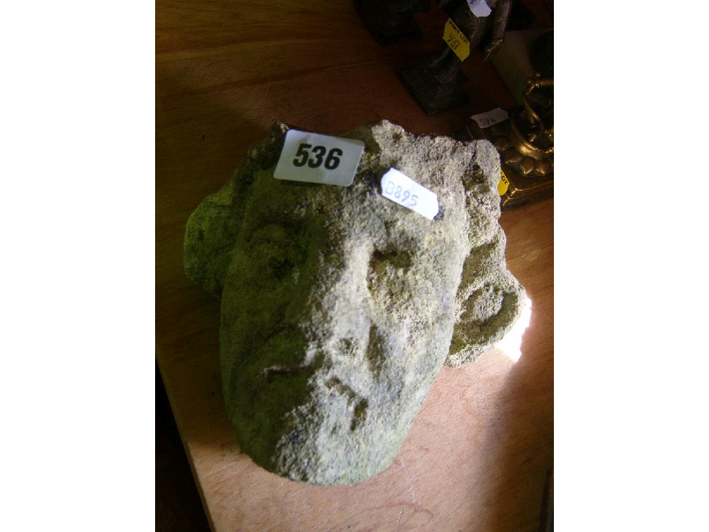 Appraisal: A weathered stone fragment of a classical style mask