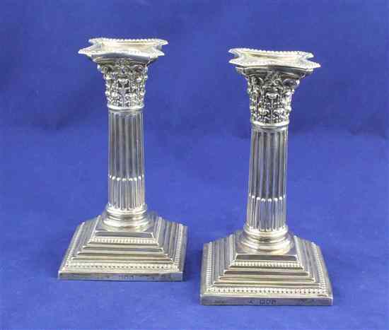 Appraisal: A pair of late Victorian silver corinthian column dwarf candlesticks