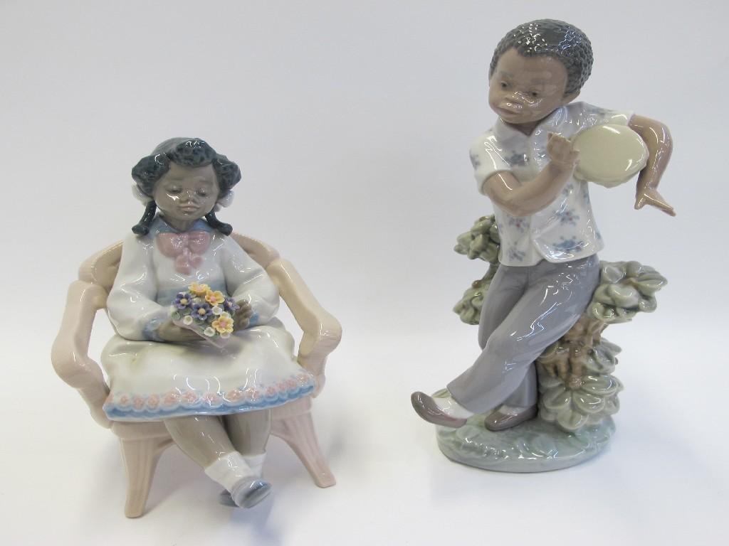 Appraisal: Lladro figure of a girl 'Sitting Pretty' and a boy