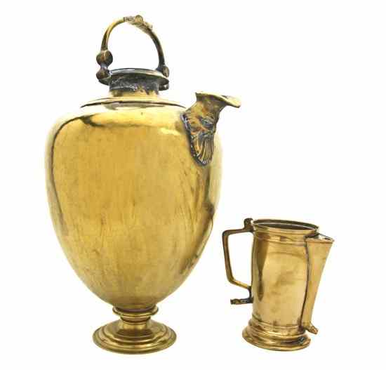 Appraisal: Two Continental Brass Pitchers each having an applied handle the