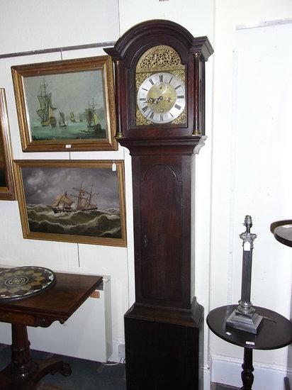 Appraisal: AN OAK LONG CASE CLOCK with arched brass dial by