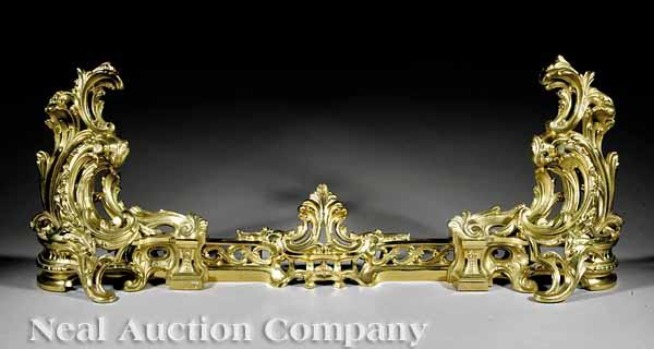 Appraisal: A French Rococo-Style Brass Fender exuberantly modeled scroll and acanthus