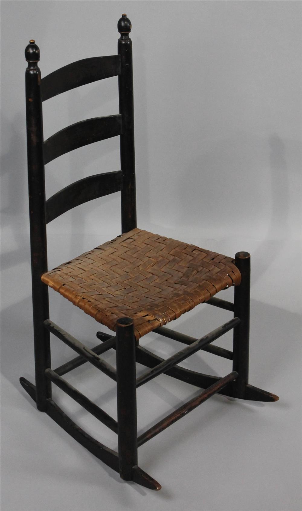 Appraisal: SHAKER STYLE BLACK PAINTED ROCKING CHAIR having a back with