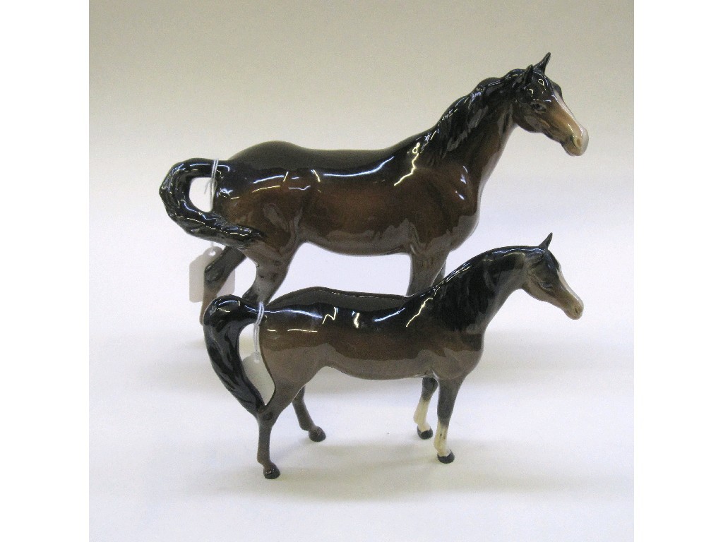 Appraisal: Two Beswick figures of brown horses to include a swish