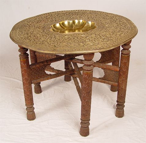 Appraisal: BRASS TOP PERSIAN TABLE Carved legs support a tooled brass