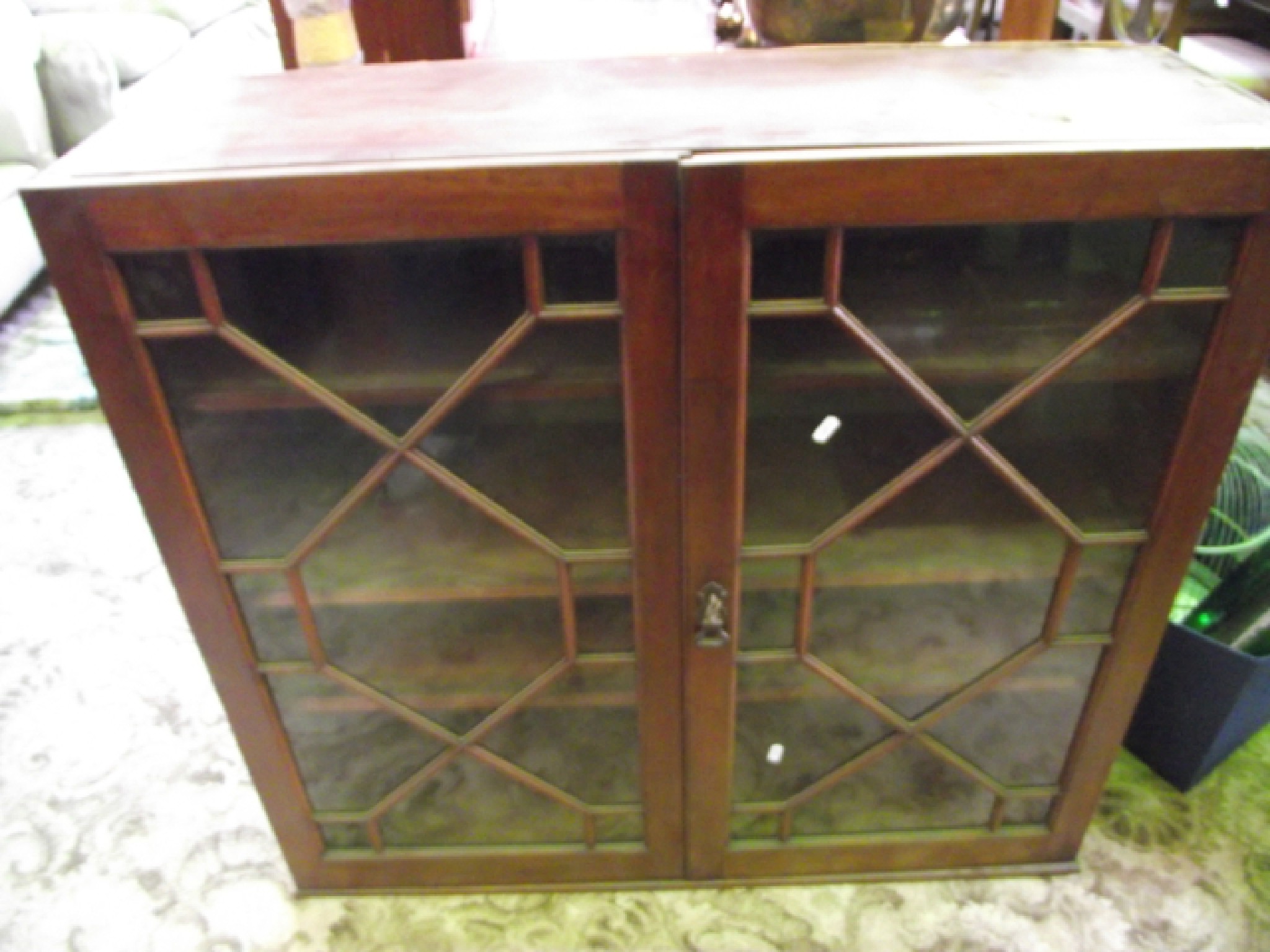 Appraisal: A th century mahogany cupboard enclosed by two astragal glazed