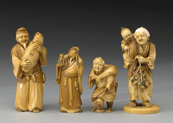 Appraisal: Four stained ivory figural okimono Including a child carried on