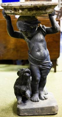 Appraisal: A bird bath with lead putto and dog base cm