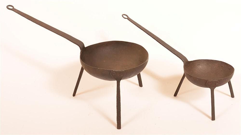 Appraisal: Two Wrought Iron Kettles on Tripod Bases Two Late th