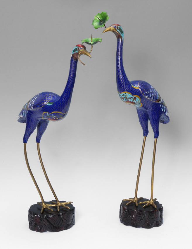 Appraisal: PAIR FIGURAL CLOISONNE CRANES Each holding a flower in its