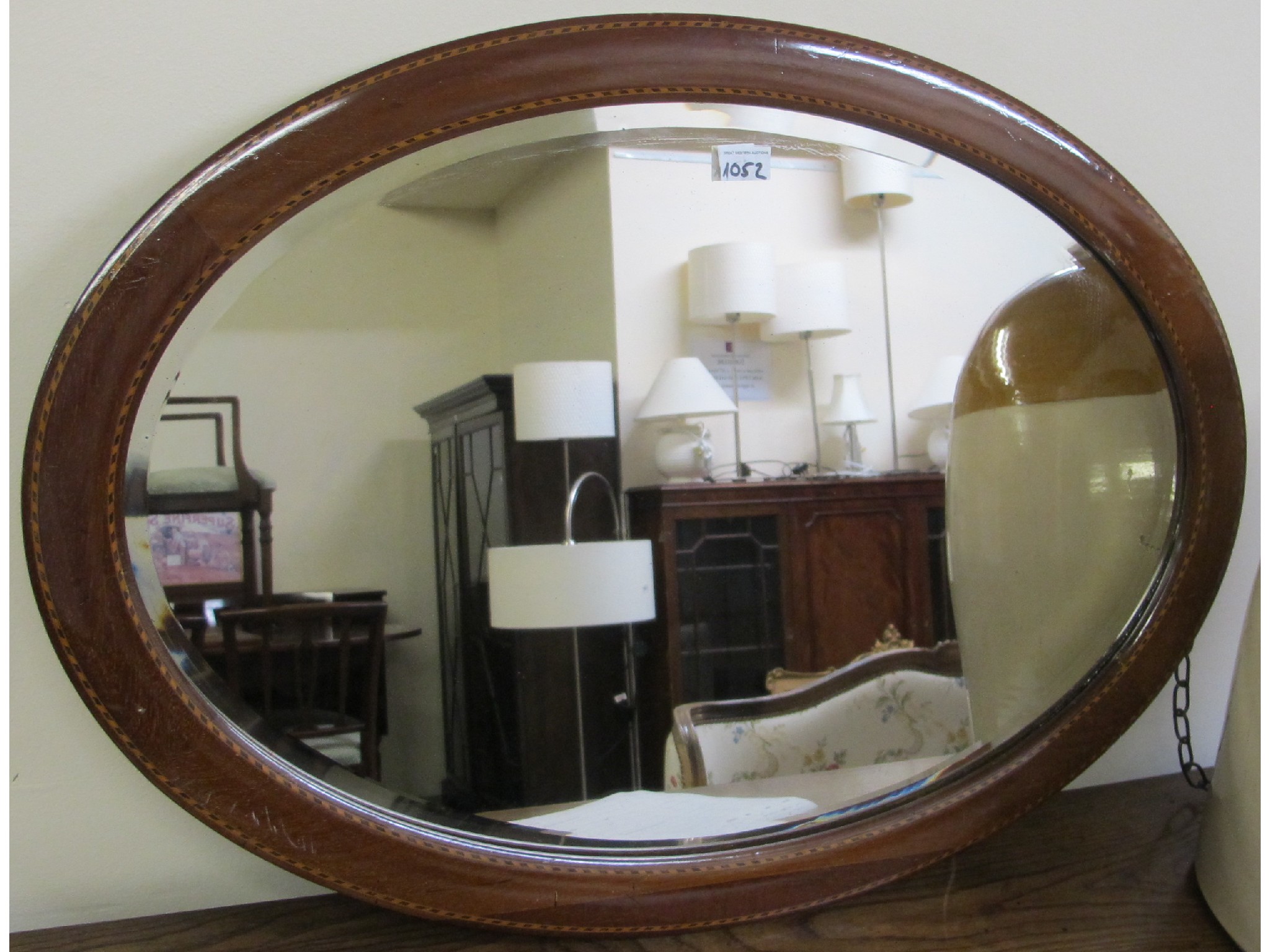 Appraisal: An oval inlaid mahogany mirror