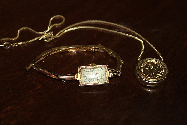 Appraisal: A CT GOLD LADIES WATCH with relief border decoration together