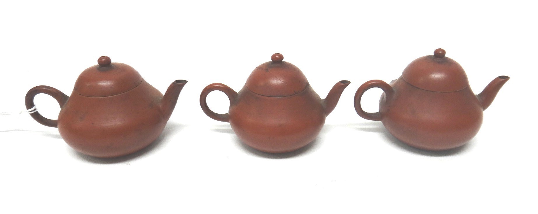 Appraisal: Three miniature Chinese Yixing teapots and covers each of squat