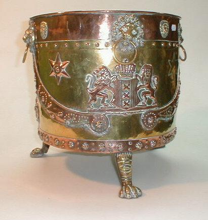 Appraisal: A copper and brass circular coal box with lion mask