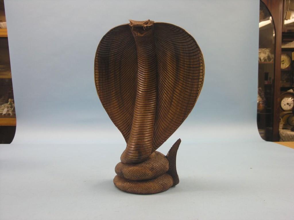 Appraisal: An Indian carved wood cobra in