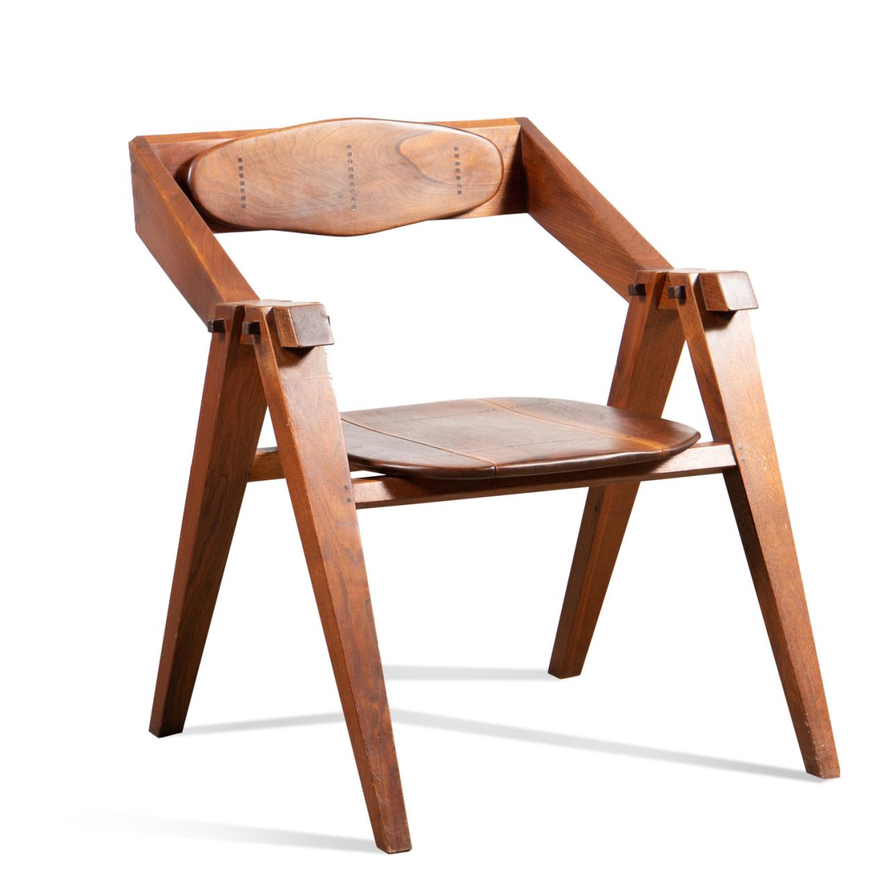 Appraisal: STUDIO FURNITURE SCULPTURAL WALNUT ARM CHAIR American Studio Furniture style