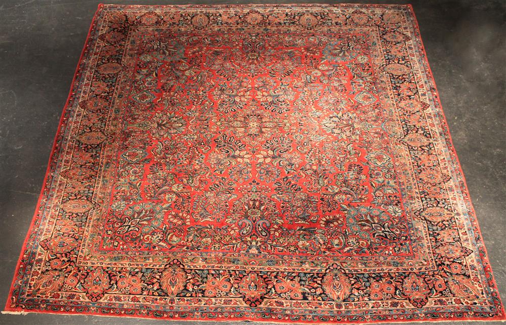 Appraisal: SAROUK CARPET the wine-red field featuring floral stems and flower-filled