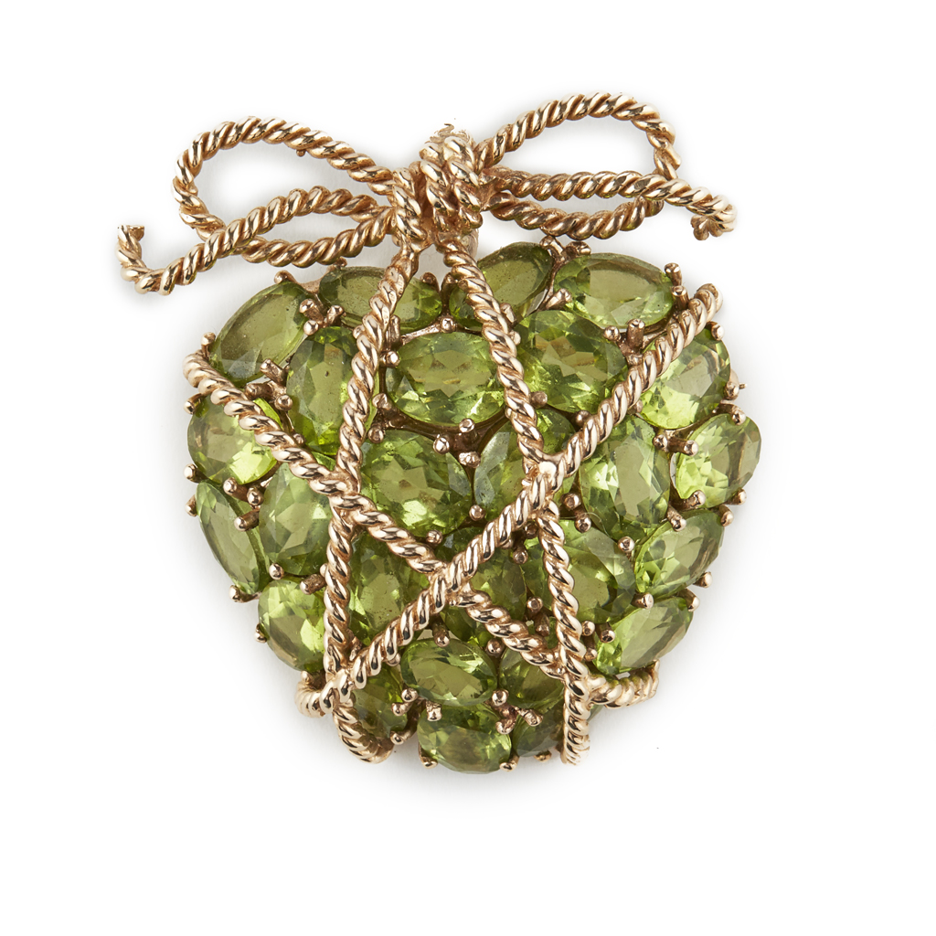 Appraisal: A peridot set heart brooch set throughout with oval cut