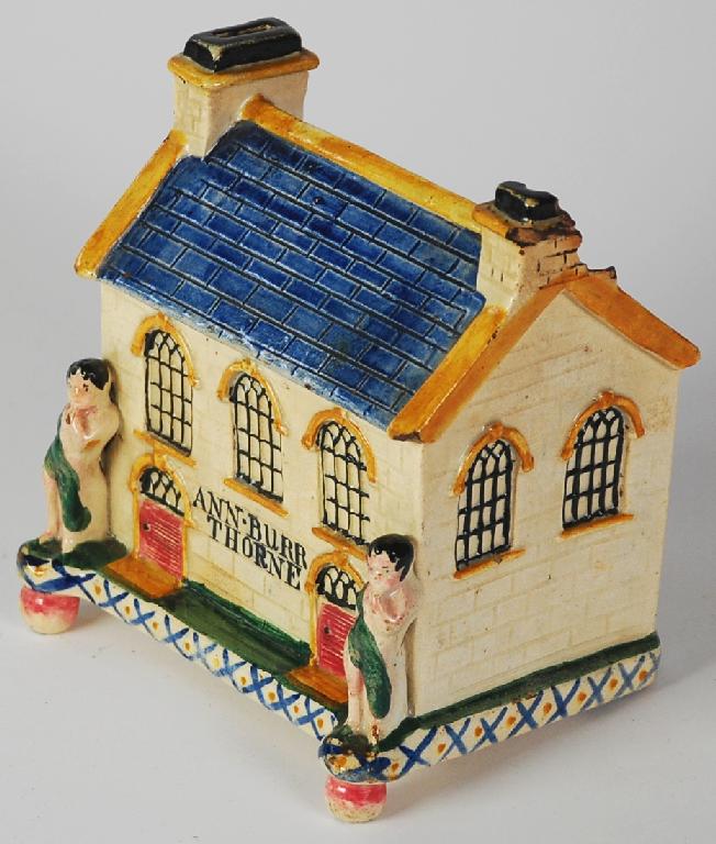 Appraisal: NINETEENTH CENTURY STAFFORDSHIRE MOULDED POTTERY MONEY BOX painted in colours