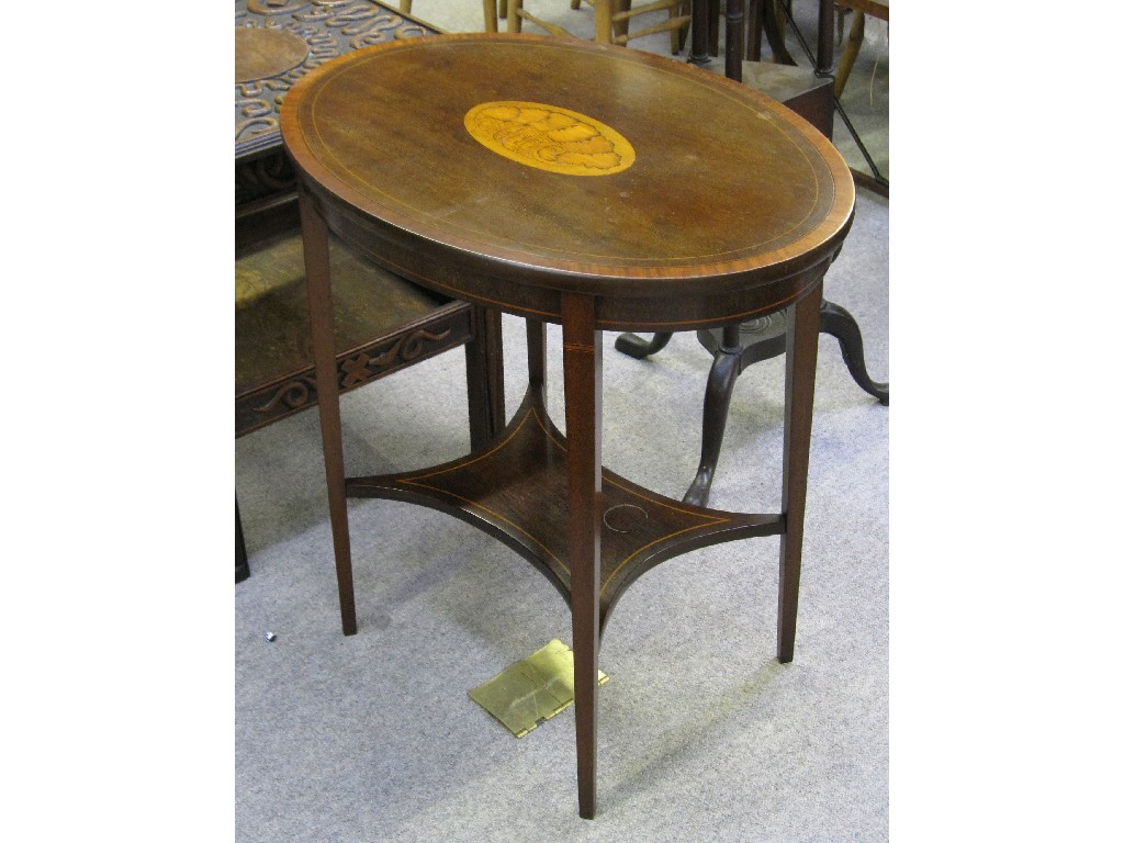 Appraisal: Edwardian mahogany oval two tier table with crossbanded inlaid patera