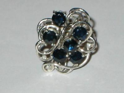 Appraisal: A SAPPHIRE AND DIAMOND DRESS RING comprising six dark round