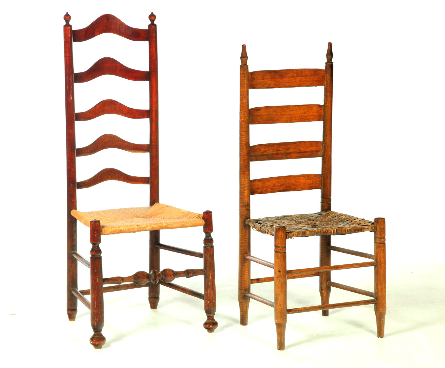 Appraisal: TWO LADDER BACK SIDE CHAIRS American th century mixed woods