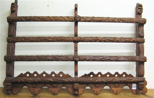 Appraisal: CARVED MAHOGANY WALL PLATE RACK with two levels of carved