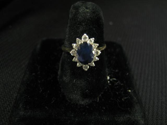 Appraisal: Sapphire Diamond Ring oval deep blue gem surrounded by diamonds