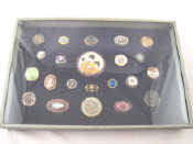 Appraisal: A display case of various buttons including enamel micromosaic portrait