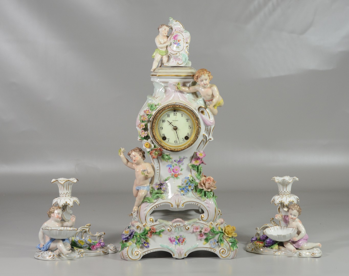 Appraisal: -Piece Dresden porcelain clock set footed floral putti decorated clock