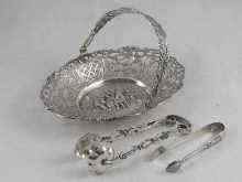 Appraisal: A Dutch silver swing handled sweetmeats basket with relief canalside