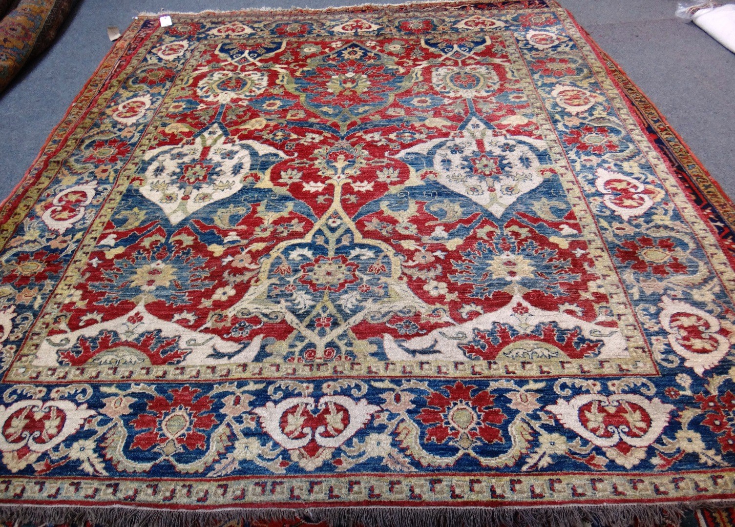 Appraisal: A modern Afghan carpet the madder field with bold cartouche