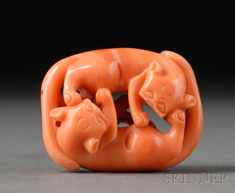 Appraisal: Coral Toggle th century depicting a pair of intertwined lions