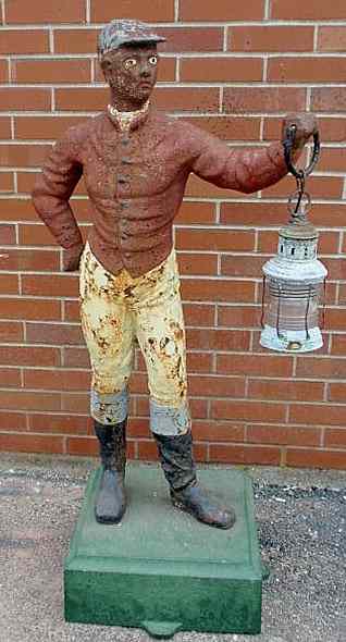 Appraisal: Cast iron jockey th c with paint decoration and green