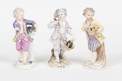 Appraisal: Three Meissen figures of boys each with a basket of