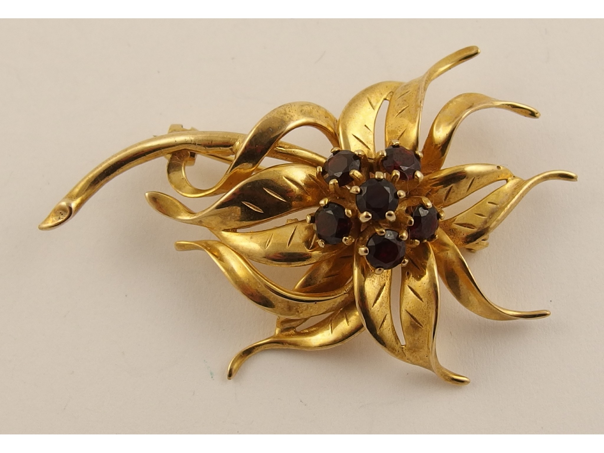 Appraisal: A ct garnet set flower brooch