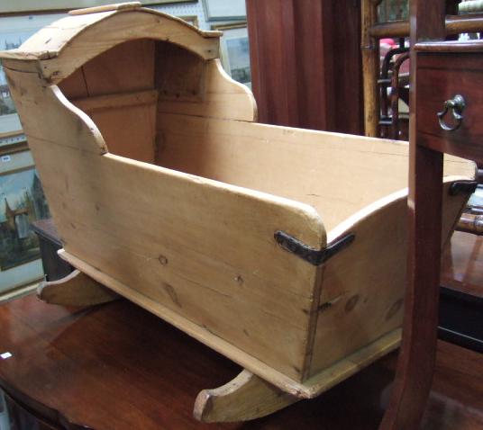 Appraisal: A th century pine rocking cot with arch hood together