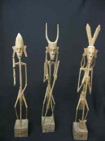 Appraisal: Carved Wooden Tribal Figurines each ''stick'' style carved from a