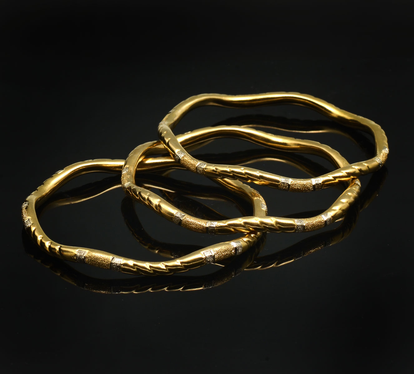 Appraisal: - K TWO TONED TEXTURED BANGLES Middle Eastern stylized ''Harem''