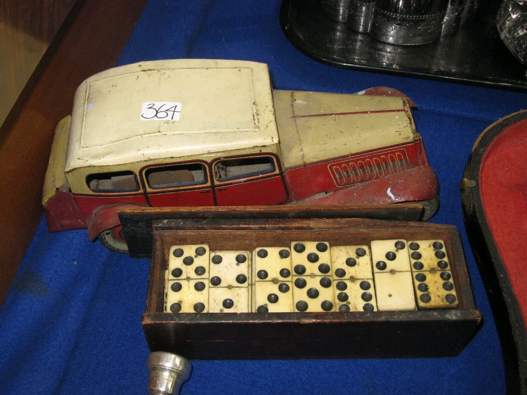 Appraisal: Lot comprising set of dominoes and a clockwork tinplate car