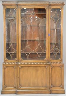 Appraisal: Mahogany breakfront with glazed bowed glass in two parts one