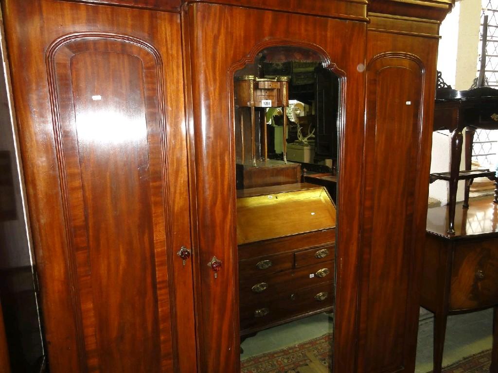 Appraisal: A Victorian mahogany breakfront triple wardrobe the central section enclosed