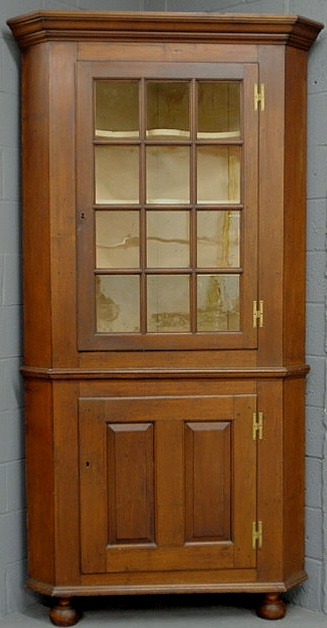 Appraisal: Pennsylvania walnut one-piece corner cupboard th c with a molded