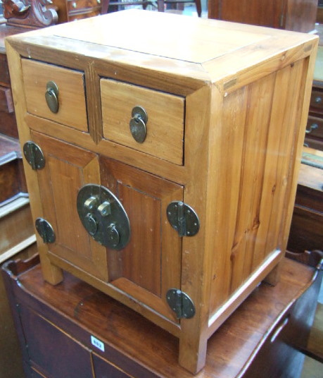 Appraisal: A small th century hardwood side cabinet with a pair