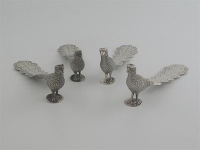 Appraisal: A set of four Mexican metalware pepperettes table decorations cast