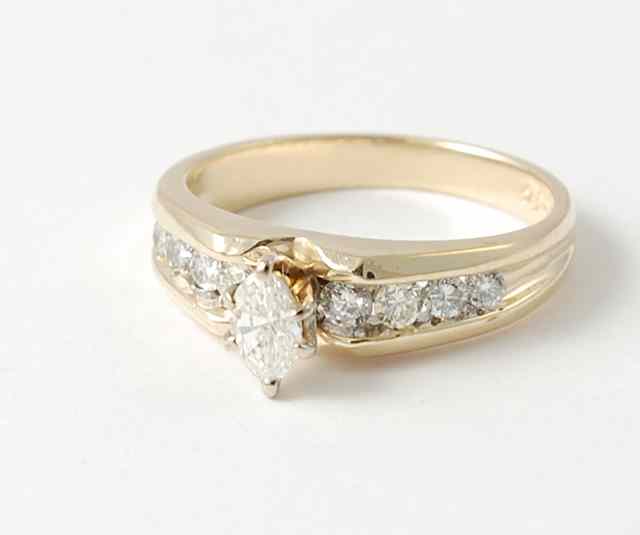 Appraisal: DIAMOND AND FOURTEEN KARAT GOLD RING centering a single pear-cut