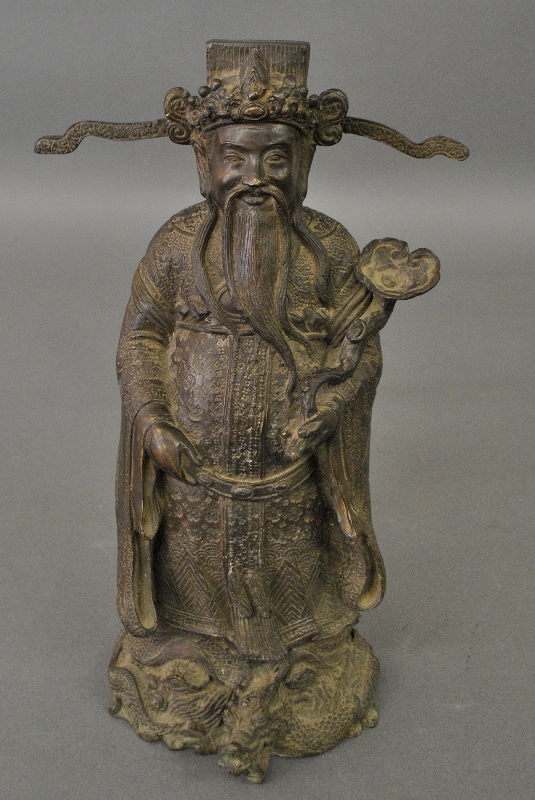 Appraisal: - Chinese bronze figure of a scholar holding a Ruyi