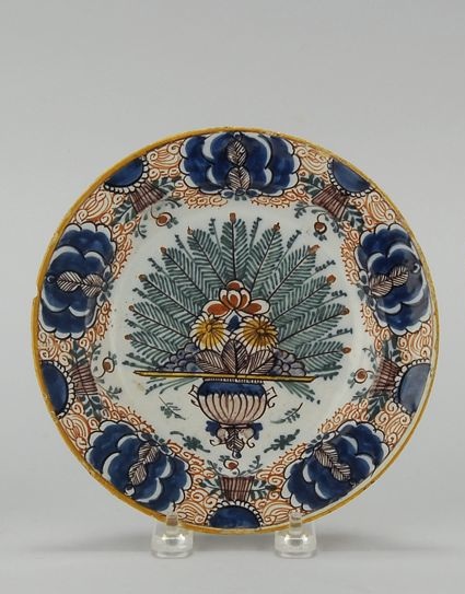 Appraisal: DELFT POTTERY PEACOCK PLATE Circa With polychrome decoration and mustard-yellow